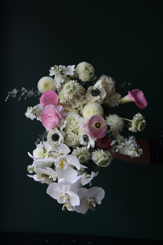 Sculptural white and blush floral arrangement with layered seasonal blooms